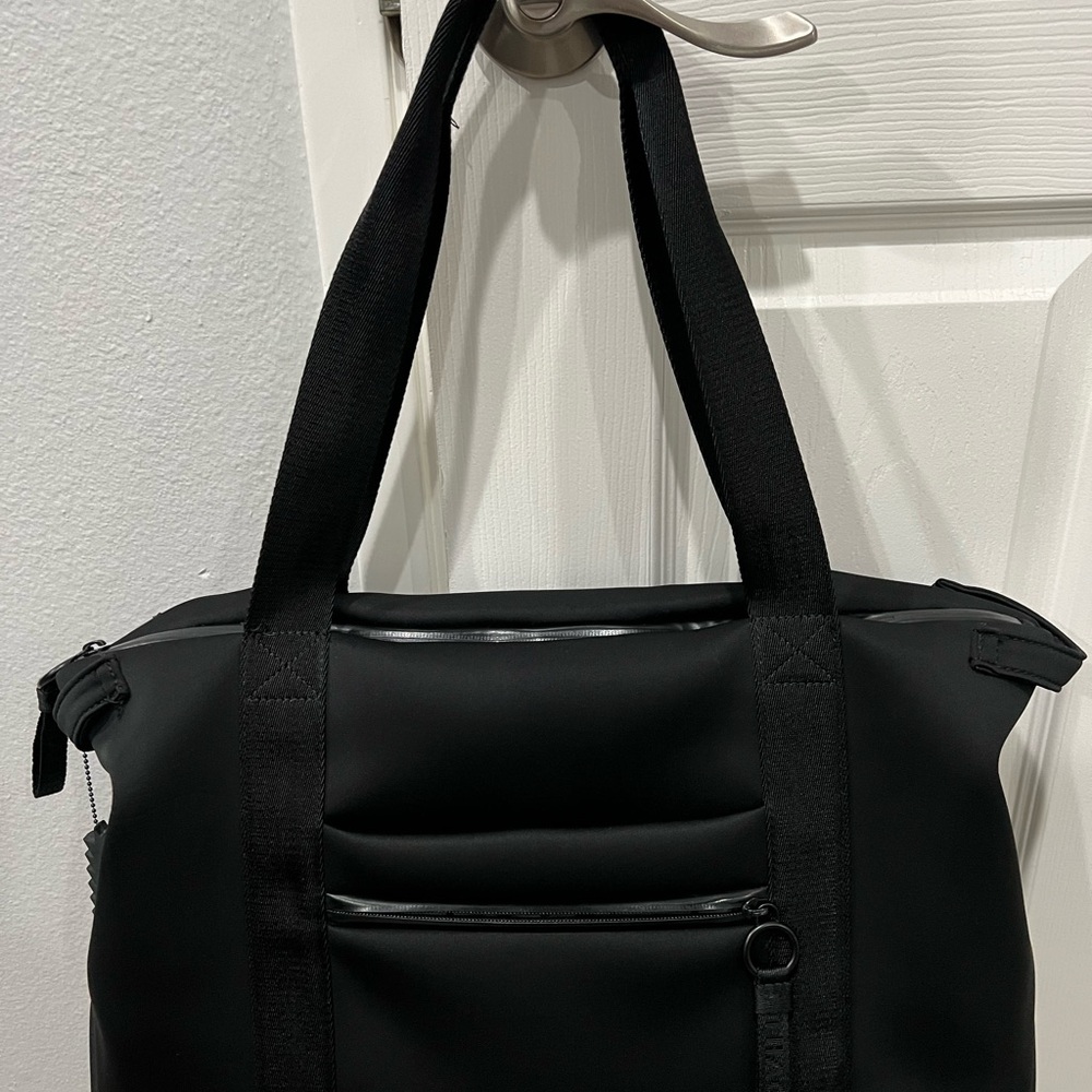 Black Duffel Bag with Structured Design and Fabric Handles.